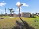 Single-Gathering home with palm trees and a green roof at 9567 Honeymoon Dr, Port Charlotte, FL 33981