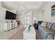 Spacious living area featuring a large TV and comfortable seating at 9567 Honeymoon Dr, Port Charlotte, FL 33981