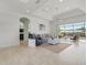 Bright living room with water view, comfortable seating, and tiled floors at 9567 Honeymoon Dr, Port Charlotte, FL 33981