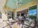 Covered patio with comfortable seating overlooking pool and canal at 9567 Honeymoon Dr, Port Charlotte, FL 33981