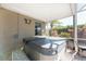 Covered hot tub on a screened-in patio at 112 Abercrombie Ave, Englewood, FL 34223