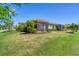 House with screened patio and lush landscaping at 11201 Mcdermott Ct, Englewood, FL 34223