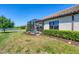 Screened patio and well-manicured backyard with pond view at 11201 Mcdermott Ct, Englewood, FL 34223