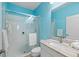 Bathroom with blue walls, walk-in shower, and vanity at 11241 Mc Dermott Ct, Englewood, FL 34223