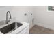 Bright laundry room with modern sink and tile floor at 13442 Keystone Blvd, Port Charlotte, FL 33981