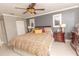 Bright bedroom with king-size bed and ceiling fan at 1401 S Mccall Rd # 306B, Englewood, FL 34223
