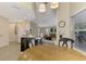 Kitchen nook has wood table, chairs, and views of the backyard at 14049 Willow Glen Ct # 242, Port Charlotte, FL 33953