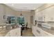 Spacious kitchen with white cabinets, granite counters, and breakfast nook at 14049 Willow Glen Ct # 242, Port Charlotte, FL 33953