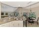 Eat-in kitchen includes granite counters, white cabinets & view to living room at 14049 Willow Glen Ct # 242, Port Charlotte, FL 33953