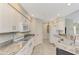 Bright kitchen features white cabinets, granite countertops, and stainless steel appliances at 14049 Willow Glen Ct # 242, Port Charlotte, FL 33953