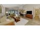 Open living space with a view of the kitchen and patio at 14049 Willow Glen Ct # 242, Port Charlotte, FL 33953