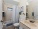 Bathroom with tub, toilet, sink, and shower curtain at 1469 Purple Ln, North Port, FL 34286