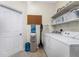 Laundry room with washer, dryer, shelving, and water dispenser at 1469 Purple Ln, North Port, FL 34286