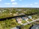 Aerial view of a waterfront home with a private dock and scenic canal views at 15104 Aldama Cir, Port Charlotte, FL 33981