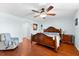 Bright bedroom featuring a king-size bed and hardwood floors at 15104 Aldama Cir, Port Charlotte, FL 33981