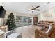 Living room with leather furniture, Christmas tree, and pool view at 15104 Aldama Cir, Port Charlotte, FL 33981