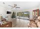 Living area with leather sofas, a Christmas tree, and sliding doors to the pool at 15104 Aldama Cir, Port Charlotte, FL 33981