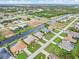 Aerial view of canal-front homes in a residential neighborhood with lush landscaping at 171 Medalist Rd, Rotonda West, FL 33947