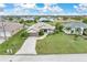 An aerial view of a house with a large front yard and driveway at 171 Medalist Rd, Rotonda West, FL 33947