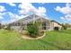 Screened-in pool and patio area with lush green lawn at 171 Medalist Rd, Rotonda West, FL 33947