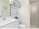 Well-lit bathroom with a single vanity, toilet, and a shower showcasing practical design and cleanliness at 171 Medalist Rd, Rotonda West, FL 33947