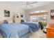 Well-lit bedroom features two beds, window, and decor that creates an inviting and comfortable space at 171 Medalist Rd, Rotonda West, FL 33947