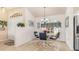 Cozy dining area features tile flooring and a charming chandelier above a round table set for four at 171 Medalist Rd, Rotonda West, FL 33947