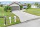 Concrete driveway and mailbox with house number plaque and lush green lawn at 171 Medalist Rd, Rotonda West, FL 33947