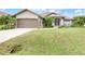 Front exterior of a single-story home with a two-car garage at 171 Medalist Rd, Rotonda West, FL 33947