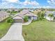 Aerial view of a single-Gathering home with a well-manicured lawn and landscaping at 171 Medalist Rd, Rotonda West, FL 33947