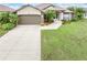 Beautiful single Gathering home with a two car garage and landscaped front yard at 171 Medalist Rd, Rotonda West, FL 33947