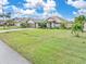 Single-story home with attached two-car garage and large lawn at 171 Medalist Rd, Rotonda West, FL 33947