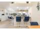 Kitchen bar with granite countertops, modern stools, and stainless steel appliances in a bright and airy space at 171 Medalist Rd, Rotonda West, FL 33947