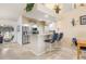 Kitchen bar with granite counters, stainless steel appliances, and seating offering a view into the dining area at 171 Medalist Rd, Rotonda West, FL 33947