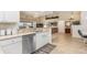Bright kitchen featuring granite countertops, white cabinets, and stainless steel appliances with adjacent living area at 171 Medalist Rd, Rotonda West, FL 33947