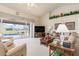 The living room features sliding doors that open to a screened-in pool area at 171 Medalist Rd, Rotonda West, FL 33947