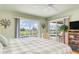 Serene main bedroom with pool views, neutral tones, and a comfortable seating area for relaxation and privacy at 171 Medalist Rd, Rotonda West, FL 33947