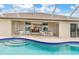 Beautiful outdoor pool with seating and a view of the home's open floor plan at 171 Medalist Rd, Rotonda West, FL 33947