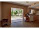 View of backyard from kitchen, featuring patio and trees at 1860 Bluebird Ln, Englewood, FL 34224