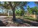 Fenced backyard with a shed and large oak tree at 1860 Bluebird Ln, Englewood, FL 34224