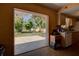 View of backyard from kitchen, featuring patio and trees at 1860 Bluebird Ln, Englewood, FL 34224