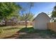 Backyard view of house with shed and deck at 1860 Bluebird Ln, Englewood, FL 34224