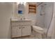 Clean bathroom with shower, toilet and vanity with a white sink at 1860 Bluebird Ln, Englewood, FL 34224