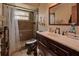 Bathroom with dark vanity, toilet and shower with a granite finish at 1860 Bluebird Ln, Englewood, FL 34224