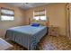 Spacious bedroom with blue and white striped bedding, and wood nightstand at 1860 Bluebird Ln, Englewood, FL 34224
