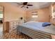 Bedroom with dresser, ceiling fan and striped bedding at 1860 Bluebird Ln, Englewood, FL 34224