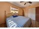 Bright bedroom with a striped comforter and wood-framed bed at 1860 Bluebird Ln, Englewood, FL 34224