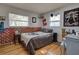 Bedroom with skull blanket, wood floors and brick accent wall at 1860 Bluebird Ln, Englewood, FL 34224