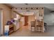 Kitchen with wood cabinets, white appliances, and breakfast bar at 1860 Bluebird Ln, Englewood, FL 34224