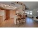 Kitchen with wood cabinets, white appliances, and breakfast bar at 1860 Bluebird Ln, Englewood, FL 34224